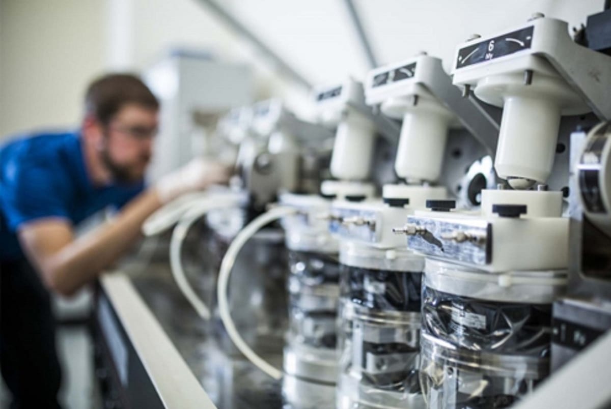 Un technicien règle des appareils d'analyse en laboratoire